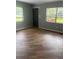 An empty living room with wood flooring and a gray color scheme at 717 Whiteway Dr, Brooksville, FL 34601