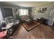 Cozy living room featuring hardwood floors, a stylish rug, and comfortable seating at 717 Whiteway Dr, Brooksville, FL 34601