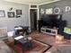 Cozy living room featuring hardwood floors, a stylish rug, and comfortable seating at 717 Whiteway Dr, Brooksville, FL 34601