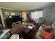 Comfortable living room with hardwood floors, a large TV, and cozy seating area at 717 Whiteway Dr, Brooksville, FL 34601