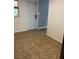 Room with tile floors and a white door, showcasing neutral tones at 717 Whiteway Dr, Brooksville, FL 34601