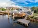 Aerial view of a waterfront home with a boat dock and spacious outdoor area at 7303 Hatteras Dr, Hudson, FL 34667