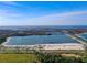 Beautiful aerial view of a white sand beach and clear blue water with waterfront activities at 7303 Hatteras Dr, Hudson, FL 34667