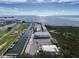 An aerial view of a marina with boats docked in the calm water and buildings along the waterfront at 7303 Hatteras Dr, Hudson, FL 34667