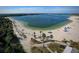 A scenic aerial view of a beach area with a lake and wakeboarding course at 7303 Hatteras Dr, Hudson, FL 34667