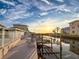 Waterfront property featuring a private dock with a boat lift along canal at sunset at 7303 Hatteras Dr, Hudson, FL 34667