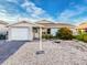 Charming single story home with a light gray exterior, attached garage, and lovely landscaping at 7303 Hatteras Dr, Hudson, FL 34667