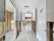 Hallway undergoing renovation with tiled flooring, and doorway, presenting an opportunity to customize and enhance the space at 7303 Hatteras Dr, Hudson, FL 34667