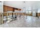 Spacious kitchen with tile floors, wooden cabinets and views to the outside at 7303 Hatteras Dr, Hudson, FL 34667