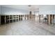 Large living room with tile floors and views into the kitchen and other living spaces at 7303 Hatteras Dr, Hudson, FL 34667