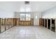 Large living room with tile floors, a window and exterior access at 7303 Hatteras Dr, Hudson, FL 34667