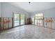 Spacious room with tiled flooring, ready for renovation, offering a bright and airy atmosphere with a view of the pool at 7303 Hatteras Dr, Hudson, FL 34667