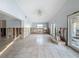 Large living room with tile floors, light blue walls and backyard access at 7303 Hatteras Dr, Hudson, FL 34667