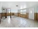 Open-concept living room with tiled floors, natural light, and ready for renovation at 7303 Hatteras Dr, Hudson, FL 34667