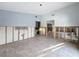 A large living area during the remodeling phase, featuring tile floors and an open layout for versatile design possibilities at 7303 Hatteras Dr, Hudson, FL 34667