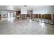 Large living room with tile floors and views into the kitchen and other living spaces at 7303 Hatteras Dr, Hudson, FL 34667