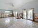 Large living room with tile floors, light blue walls and backyard access at 7303 Hatteras Dr, Hudson, FL 34667