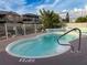 Kidney-shaped backyard pool with a depth of 3 feet surrounded by a white fence at 7303 Hatteras Dr, Hudson, FL 34667