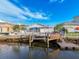 A waterfront home with fenced yard, boat lift, and dock at 7303 Hatteras Dr, Hudson, FL 34667