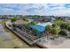Coastal restaurant featuring waterfront dining, outdoor seating, tiki bar, and picturesque views with lush surroundings at 7303 Hatteras Dr, Hudson, FL 34667