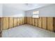 Bare room featuring light-colored tile floor and partial drywall and insulation at 7303 Hatteras Dr, Hudson, FL 34667