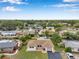 Aerial view showcases a home in a serene residential neighborhood with mature trees at 7316 Tangelo Ave, Port Richey, FL 34668