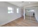 Bedroom featuring wood-look floors, large window and closet with mirrored doors at 7316 Tangelo Ave, Port Richey, FL 34668