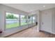 Bedroom featuring wood-look floors, closet with mirrored doors and large windows at 7316 Tangelo Ave, Port Richey, FL 34668