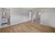 Spacious bedroom with light wood flooring, a sliding door closet, and a bathroom entrance at 7316 Tangelo Ave, Port Richey, FL 34668