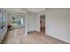 Bedroom featuring wood-look floors, large windows and closet with mirrored doors at 7316 Tangelo Ave, Port Richey, FL 34668
