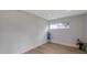 Bedroom featuring wood-look floors, large window and fresh paint at 7316 Tangelo Ave, Port Richey, FL 34668