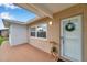 Inviting entryway featuring a beige brick wall, large windows, and a charming welcome wreath on the door at 7316 Tangelo Ave, Port Richey, FL 34668