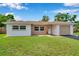 Charming single-story home featuring a well-maintained lawn and inviting curb appeal on a sunny day at 7316 Tangelo Ave, Port Richey, FL 34668