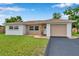 Charming single-story home featuring a well-maintained lawn and inviting curb appeal on a sunny day at 7316 Tangelo Ave, Port Richey, FL 34668