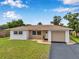 Well-maintained single-Gathering home with a cozy front porch and attached garage at 7316 Tangelo Ave, Port Richey, FL 34668