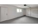 Clean and spacious garage featuring a roll-up door and extra entry door at 7316 Tangelo Ave, Port Richey, FL 34668