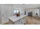 Bright kitchen featuring an island with seating, white cabinetry, and updated appliances at 7316 Tangelo Ave, Port Richey, FL 34668