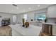 Bright kitchen with a large island, stainless steel dishwasher, and white cabinetry at 7316 Tangelo Ave, Port Richey, FL 34668