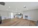 Bright and airy living room featuring an open floor plan with a modern kitchen and wood flooring at 7316 Tangelo Ave, Port Richey, FL 34668