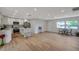 Open-concept living area featuring hardwood floors, modern kitchen, and ample natural light at 7316 Tangelo Ave, Port Richey, FL 34668