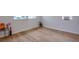 Corner of an empty room featuring wood floors and natural light from the windows at 7316 Tangelo Ave, Port Richey, FL 34668