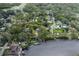 Aerial view of property highlighting waterfront location and lush, established landscaping at 7424 Grand Blvd, New Port Richey, FL 34652