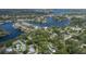 Picturesque aerial perspective of homes nestled in a lush, tree-filled community on winding waterways at 7424 Grand Blvd, New Port Richey, FL 34652