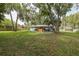 Expansive backyard surrounded by mature trees, offering privacy and a serene setting at 7424 Grand Blvd, New Port Richey, FL 34652