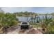 Backyard area with a waterfront dock and a fire pit at 7424 Grand Blvd, New Port Richey, FL 34652