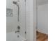 Bright bathroom featuring white subway tile in the shower and a glass shower door at 7424 Grand Blvd, New Port Richey, FL 34652