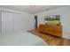 Cozy bedroom featuring hardwood floors, ample storage, and a TV for relaxing evenings at 7424 Grand Blvd, New Port Richey, FL 34652