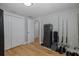 Bedroom with wood floors, closet doors, gun safe and fishing poles at 7424 Grand Blvd, New Port Richey, FL 34652