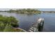 Scenic view of a wooden dock on calm water, with lush greenery on the shore at 7424 Grand Blvd, New Port Richey, FL 34652