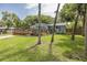 Lovely home with a beautiful wooden deck, complemented by lush greenery and trees at 7424 Grand Blvd, New Port Richey, FL 34652